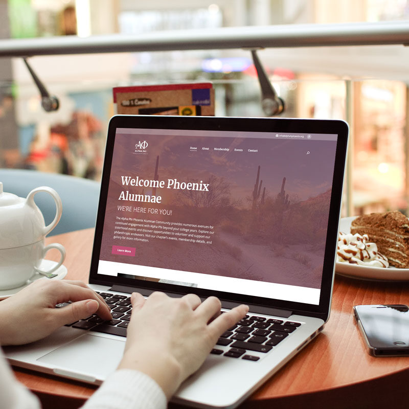 Female; laptop with Alpha Phi Phoenix Alumnae website displayed